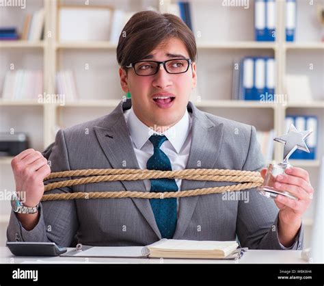 The Businessman Tied Up With Rope In Office Stock Photo Alamy