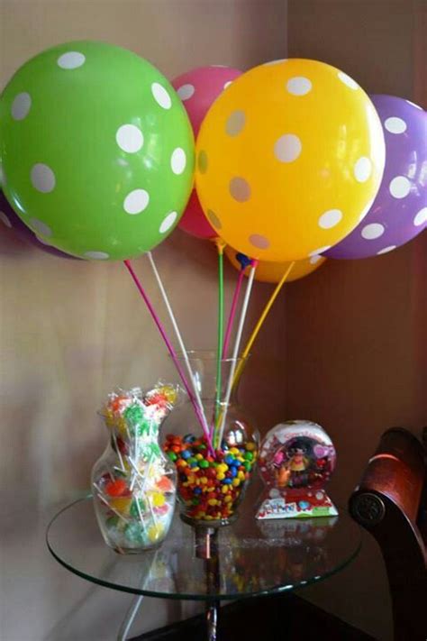 Once the balloon is filled to the desired size, stop pressing on the nozzle, slip the balloon off, and tie a knot. Balloons on Amazon, balloon sticks from oriental trading ...