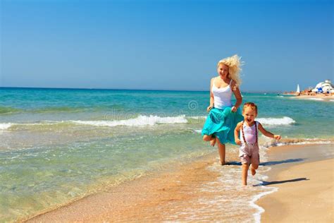 Joyful Mother And Baby Running In Surf On The Beach Stock Image Image