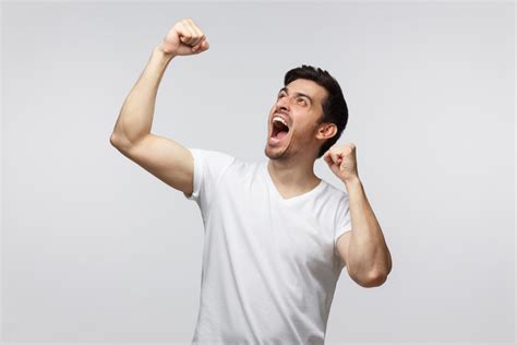 Young Successful Man Screaming Yes And Raising Clenched Fist Isolated
