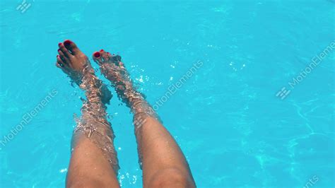 Beautiful Girl Relaxing Her Feet In Pool Water In Summer Stock Video