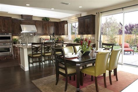 An open concept living room, dining room, and kitchen blurs the lines between each area. 29 Awesome Open-Concept Dining Room Designs