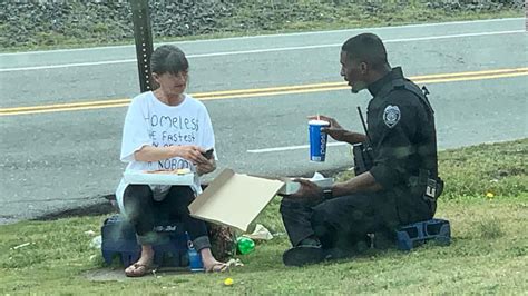 a police officer spent his lunch break sharing pizza with a homeless woman and it was captured