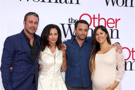 LOS ANGELES, APR 21 - Taylor Kinney, mother Pamela Heisler, and Brother