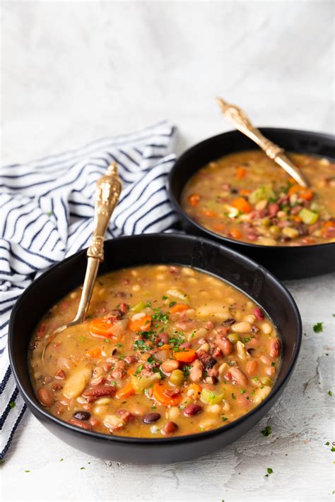 Using the back of a spoon, mash the garlic halves against the side of the slow cooker to squeeze the soft cloves out and stir into the soup. Ham and Bean Soup - Easy Peasy Meals