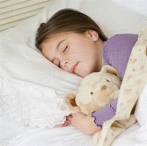 Close Up Of Girl Sleeping With Teddy Bear Stock Photo Dissolve