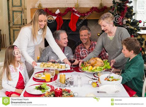 The first is a traditional christmas dinner, which includes a 10oz striploin, salt baked mash potato, carrots agrodolce, oxtail gravy, and bread pudding for dessert! Two Women Serving Christmas Dinner To Their Family Stock ...