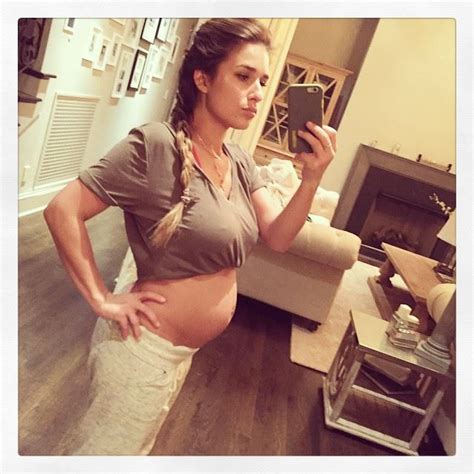 A Pregnant Woman Taking A Selfie In Her Living Room