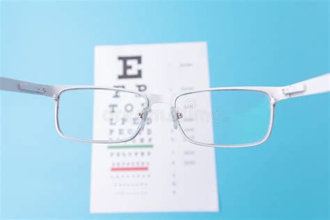 Hand Held Glasses View Of The Snellen Chart Blue Background Stock