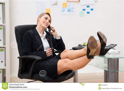 Businesswoman On The Phone With Feet On Desk Stock Image Image Of