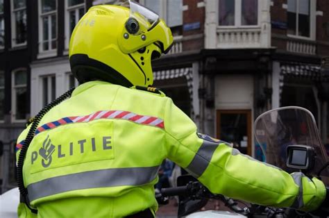 dutch police officer on motorbike patrolling in amsterdam the