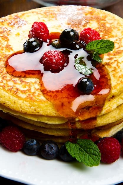 Premium Photo Pancakes With Berries And Maple Syrup