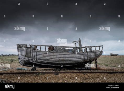 An Old Wooden Fishing Boat Abandoned On The Beach At Dungeness In Kent