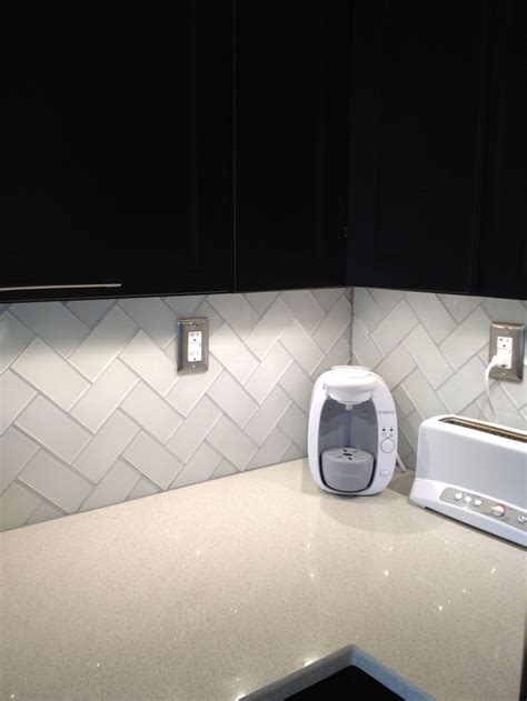 They make spaces feel these blue subway tiles extend the kitchen backsplash all the way up to the ceiling and establish a. Herringbone pattern Frosted white glass subway tile and ...