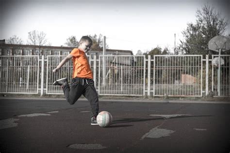 Cute Boy Kicking The Ball On City Playground Stock Image Image Of