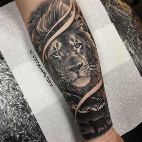 Men’s forearm sleeve tattoo, lion with silhouette in realism Mens