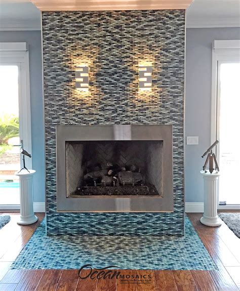 The Beauty Of Ripple Stream Blue Wavy Glass Tiles Is Impactful On This Modern Fireplace Mantel
