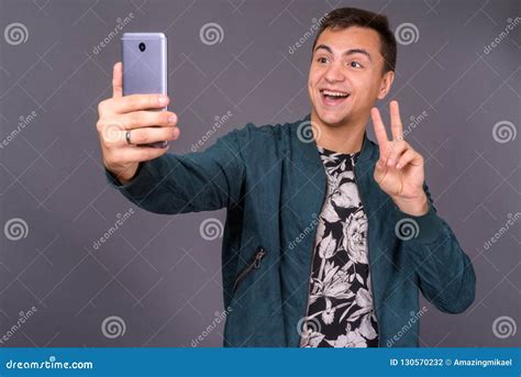 Portrait Of Young Handsome Man Taking Selfie With Mobile Phone Stock
