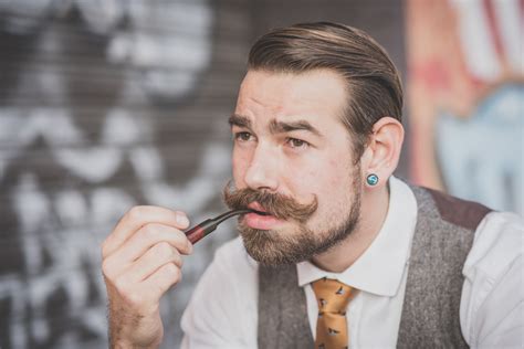 Handsome Big Moustache Hipster Man Smoking Pipe In The City Royalty