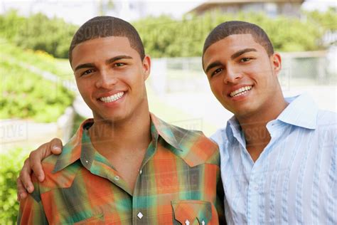 Hispanic Twin Brothers Hugging Stock Photo Dissolve