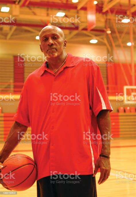 Black Male Model Poses For Pictures With A Basketball Stock Photo