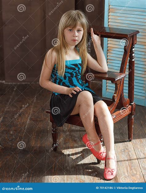 Girl 6 Years Old In Dress Sits On A Chair Stock Photo Image Of