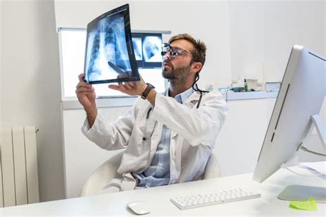 Serious Attractive Doctor Examining An X Ray Stock Image Image Of