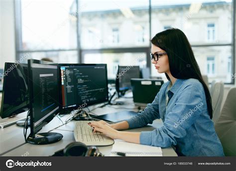 Young Woman Working And Programming On Computer In Office Stock Photo