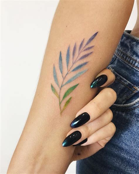 Colorful And Delicate Branch With Leaves Tattoo On The Inner Forearm