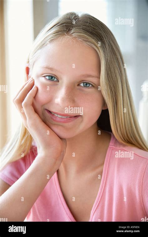 Portrait Of Caucasian Pre Teen Girl Looking At Viewer Resting Chin In