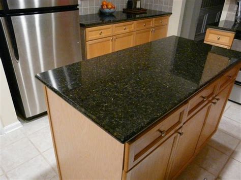 Titanium is an exotic black granite with swirls of gray and a caramel gold that create the perfect tie in for oak cabinets. Uba Tuba Granite Countertop installed in Charlotte NC | Flickr