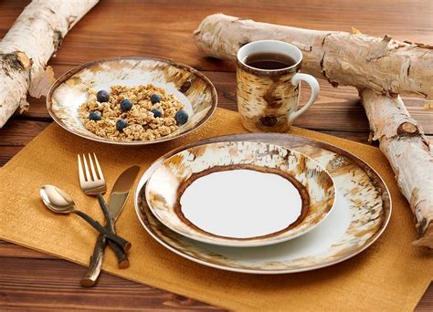 This 16 Piece Hardwood Forest Porcelain Dinnerware Set Includes 4
