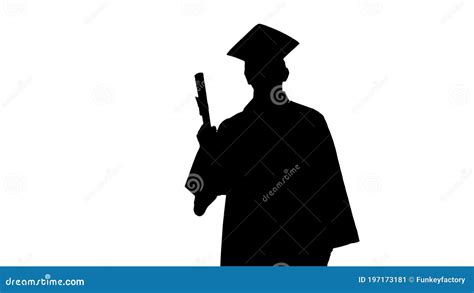 Silhouette Happy Male Student In Graduation Robe Waiving With Hi Stock