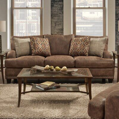 This brown reclining sectional sofa offers a pleasurable seating experience showcasing a casual appeal with its dark brown finish and contrasting stitching. Industrial Sofas You'll Love in 2020 | Wayfair