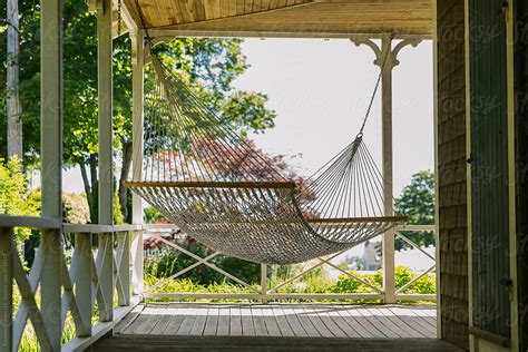 Summer Lifestyle Image Of Hammock On Porch Of Summer Home By Stocksy