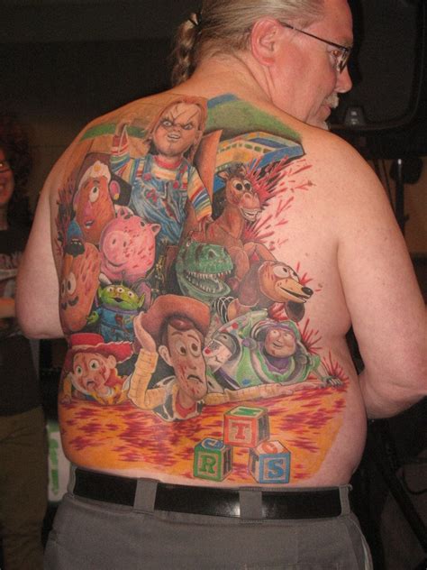 The Back Of A Man S Body Covered In Cartoon Characters Including