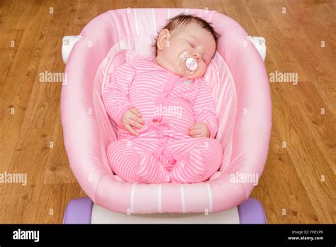 Cute Newborn Baby Sleeping With Pacifier In Mouth Lying Down On Big