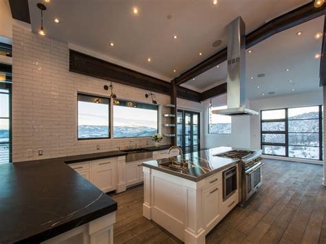 For instance, a 30 inch cooktop would work well with a 36 inch wide ceiling range hoods. Beautiful kitchen features a sloped ceiling accented with ...