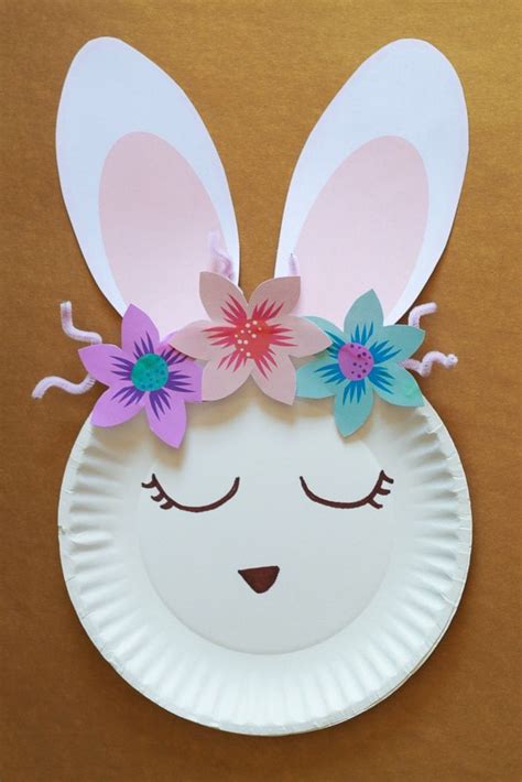A Paper Plate With An Image Of A Bunnys Face And Flowers On It