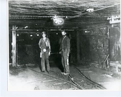 Two Coal Miners Inside The Mines Standing On The Tracks Madison