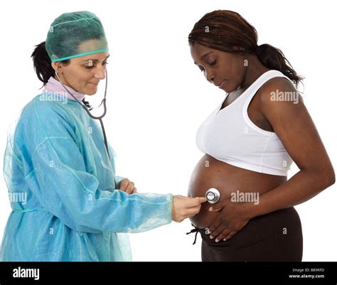 Doctor Examining A Pregnant Woman A Over White Background Stock Photo