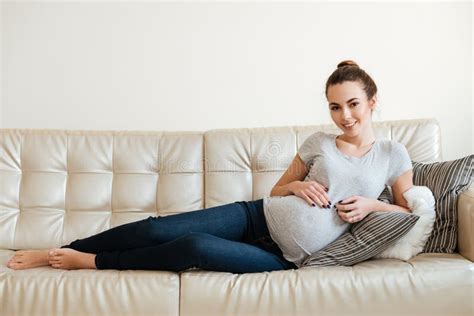 Cheerful Attractive Pregnant Young Woman Lying And Relaxing On Sofa Stock Image Image Of Girl
