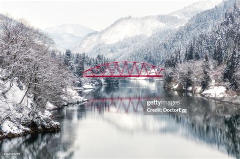 Red Bridge Across Tadami River In Winter Near Aizu Miyashita Station