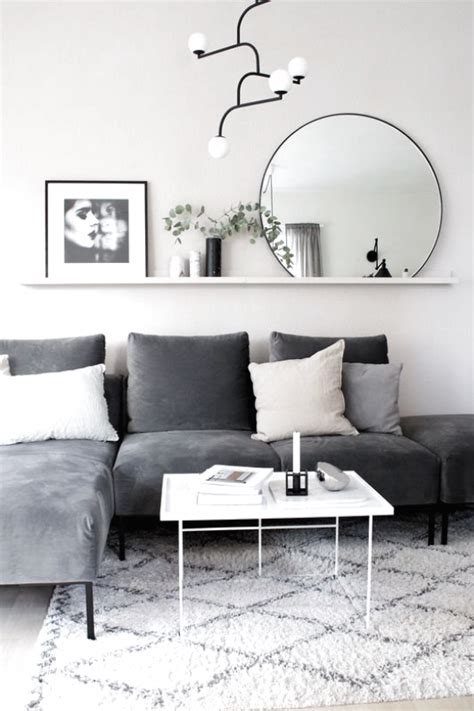 Chic city living room design with gray velvet sofa with chaise lounge, white & gray rug, vintage black & gold chest, white. Gray Living Rooms Ideas - For lovely gray living-room ...