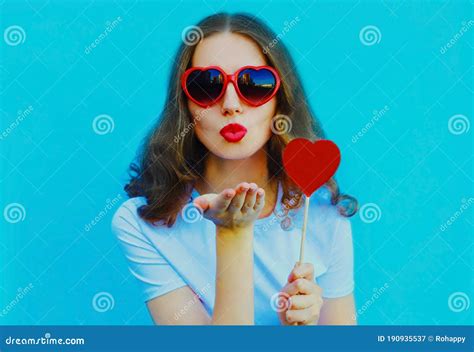 Portrait Of Beautiful Young Woman Blowing Red Lips Sweet Air Kiss With