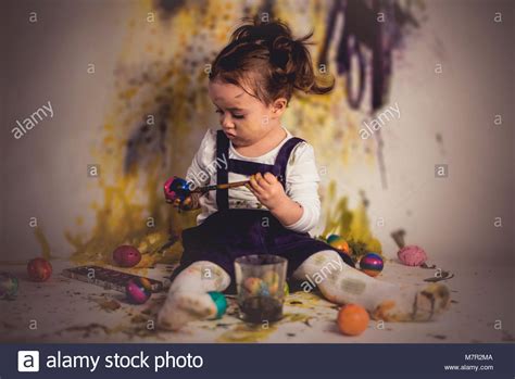 Cute Little Child Girl Is Painting Easter Eggs Stock Photo Alamy