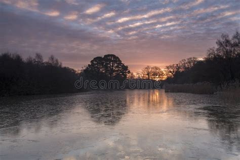 Sunrise Over A Frozen Ornamental Lake On Southampton Common Stock Photo
