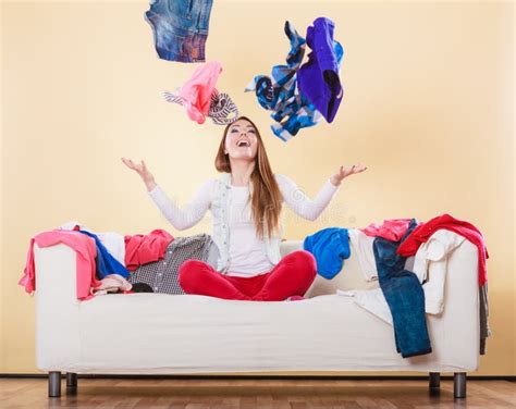 Happy Woman On Sofa In Messy Room Throwing Clothes Stock Photo Image