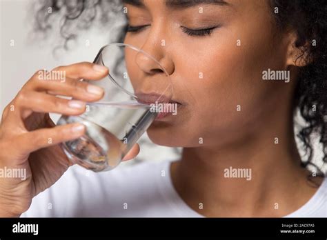 Thirsty African American Woman Drinking Clean Mineral Water Close Up