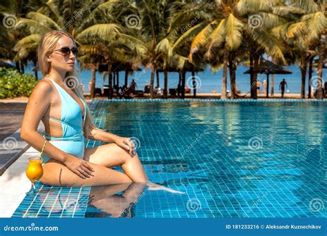 Beautiful Blonde Relaxes Sunbathes Near The Pool On Vacation Stock Photo Image Of Girl